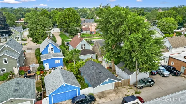 an aerial view of multiple houses with yard
