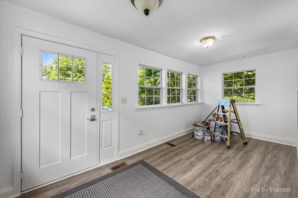 309 Griswold Street Elgin, IL 60123 - Photo 8 of 39 wooden floor in an empty room with a window