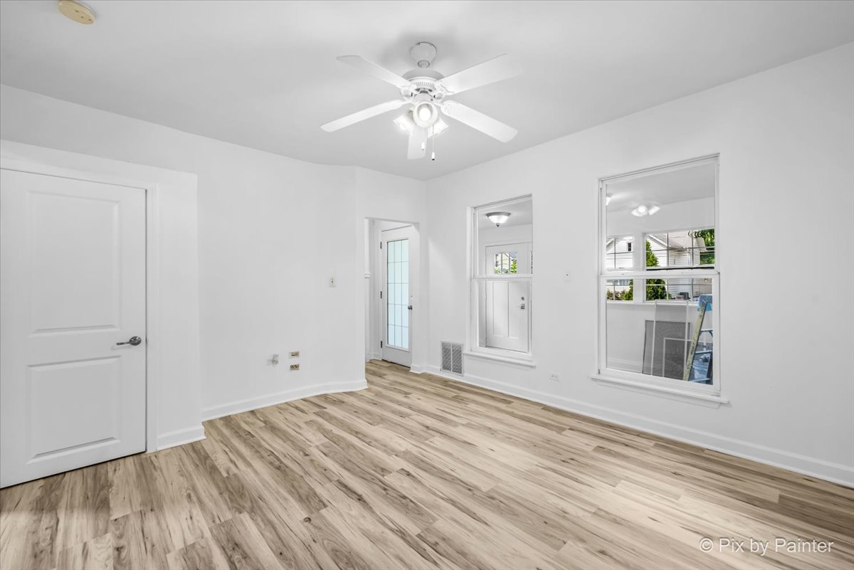 309 Griswold Street Elgin, IL 60123 - Photo 10 of 39 wooden floor in an empty room with a window