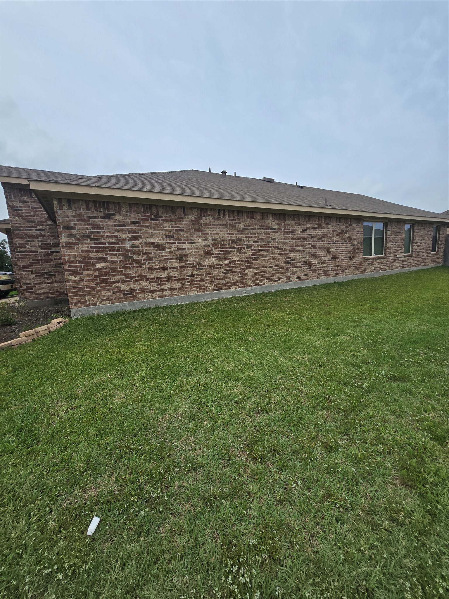 2703 Baldy Road Spring, TX 77373 - Photo 23 of 24 This photo shows the side of the single-story brick home providing a clear view of the exterior and windows.