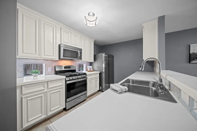 a kitchen with a sink stove and microwave