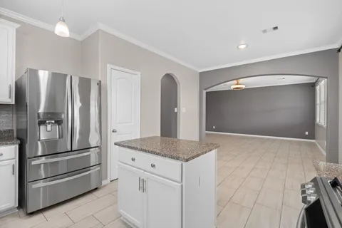 a kitchen with stainless steel appliances granite countertop a refrigerator and a sink