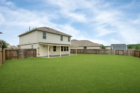 a view of a house with a yard and sitting area