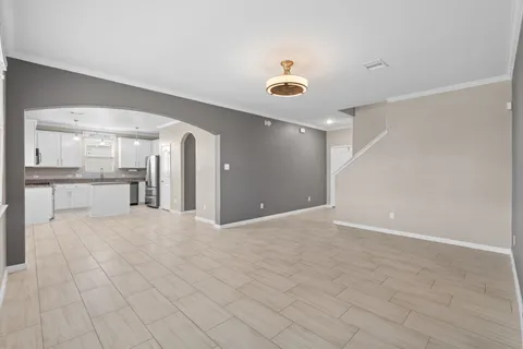a view of a kitchen with a sink and a refrigerator
