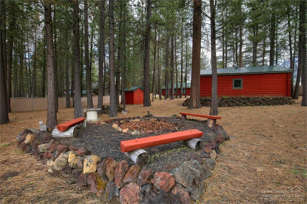 17171 Island Loop Way Bend, OR 97707 - Photo 18 of 25 a backyard of a house with barbeque oven table and chairs