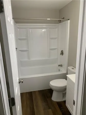 a bathroom with a toilet and a shower