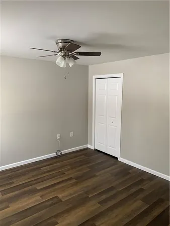 a view of a room with wooden floor and white walls