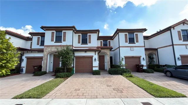 a front view of a house with a yard and a garage