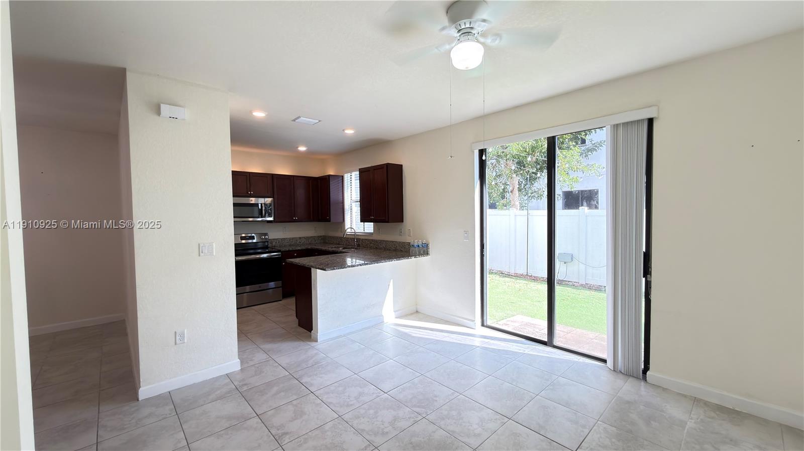 10337 West 34th Lane, Unit 10337 Hialeah, FL 33018 - Photo 13 of 50 a view of kitchen with refrigerator and microwave