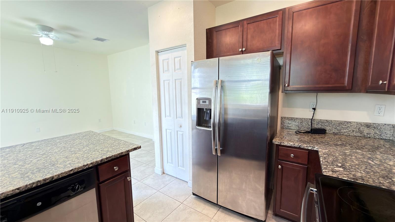 10337 West 34th Lane, Unit 10337 Hialeah, FL 33018 - Photo 17 of 50 a kitchen with stainless steel appliances granite countertop a refrigerator and a sink