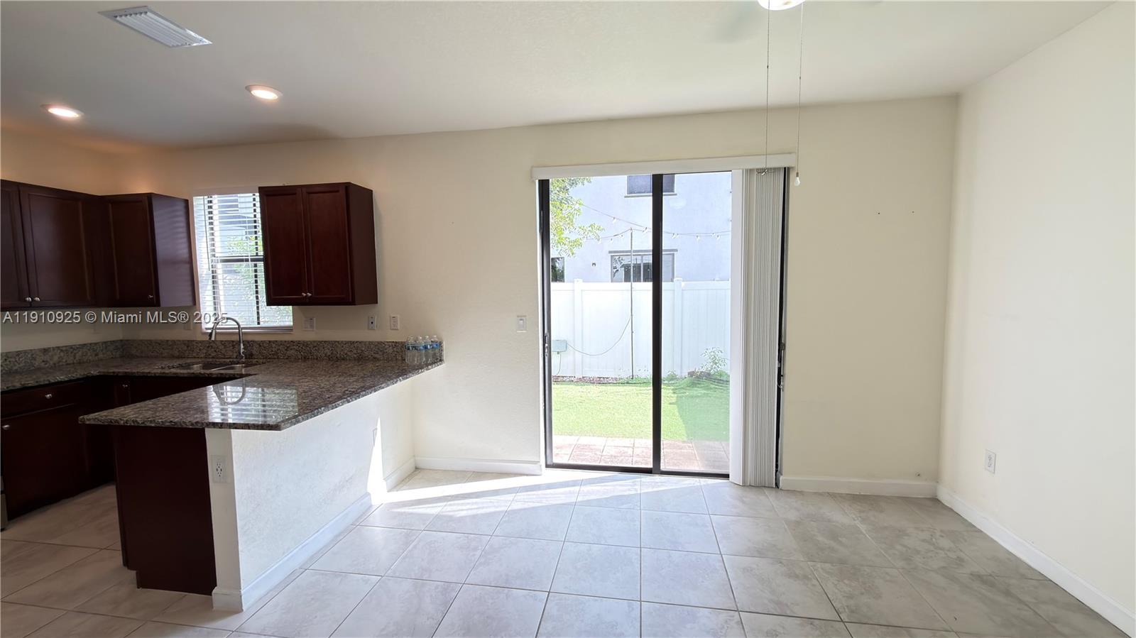10337 West 34th Lane, Unit 10337 Hialeah, FL 33018 - Photo 18 of 50 a kitchen with a sink a stove and a refrigerator