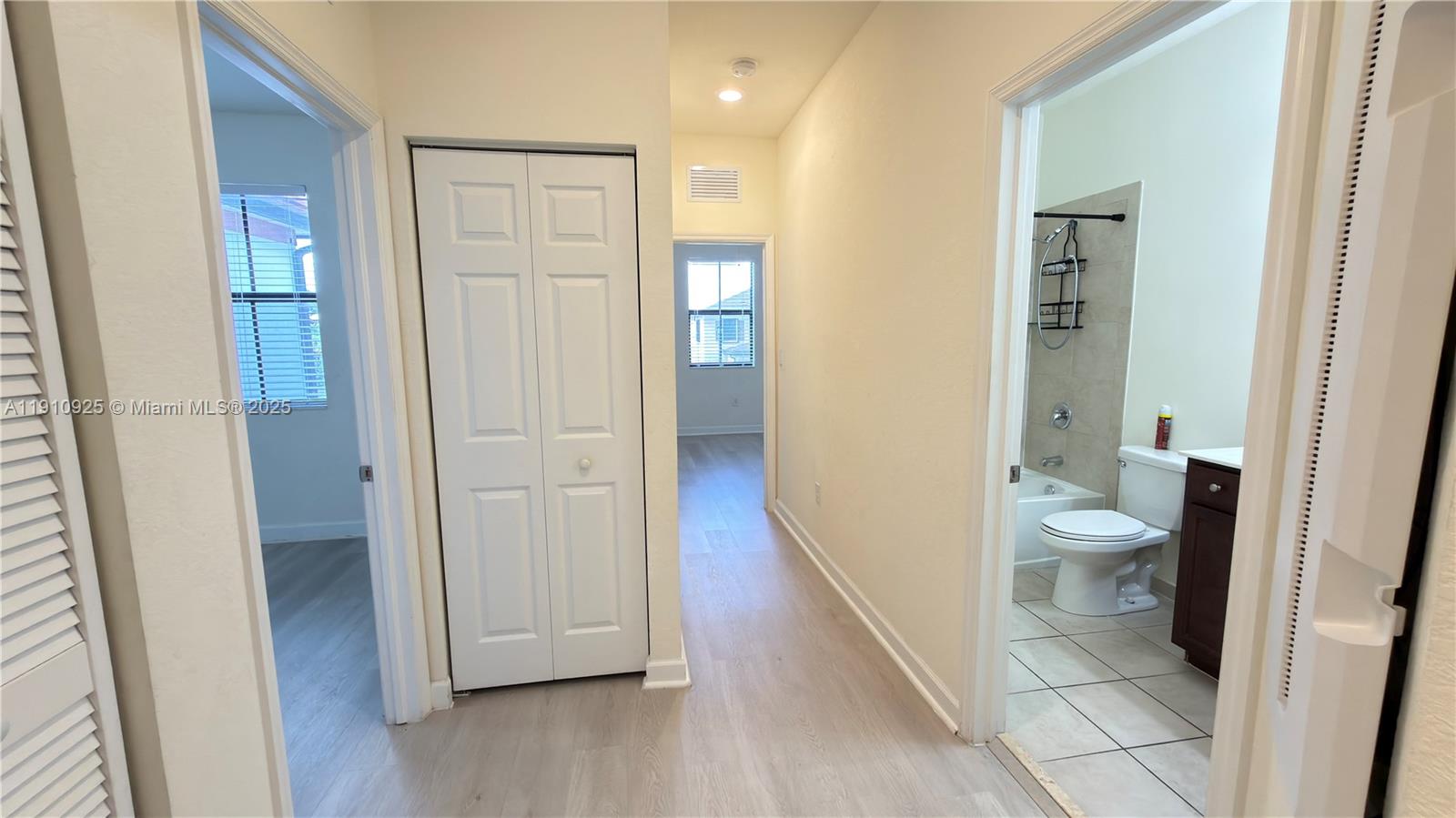 10337 West 34th Lane, Unit 10337 Hialeah, FL 33018 - Photo 25 of 50 a view of a bathroom from a hallway with toilet