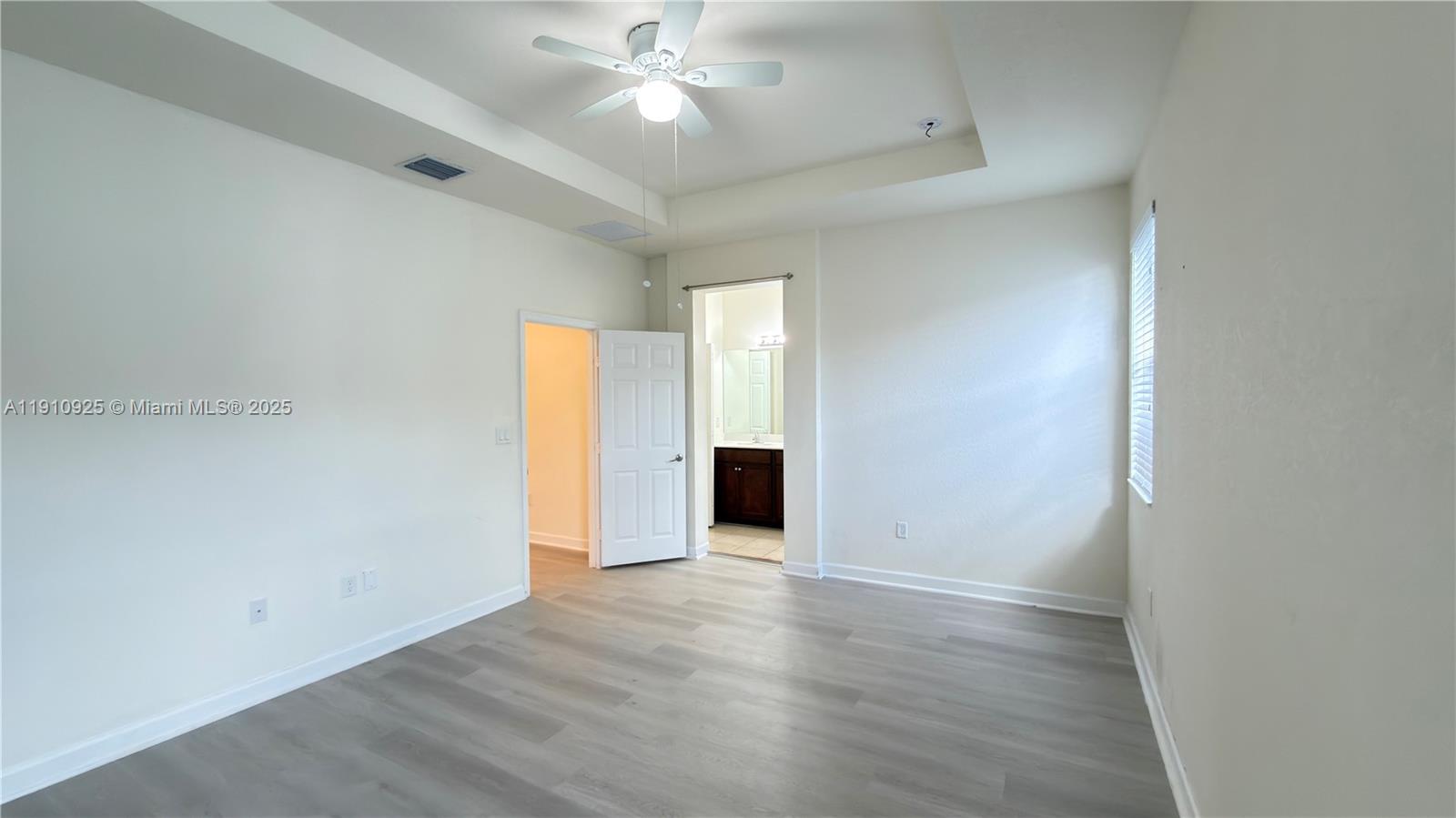 10337 West 34th Lane, Unit 10337 Hialeah, FL 33018 - Photo 29 of 50 an empty room with wooden floor and windows
