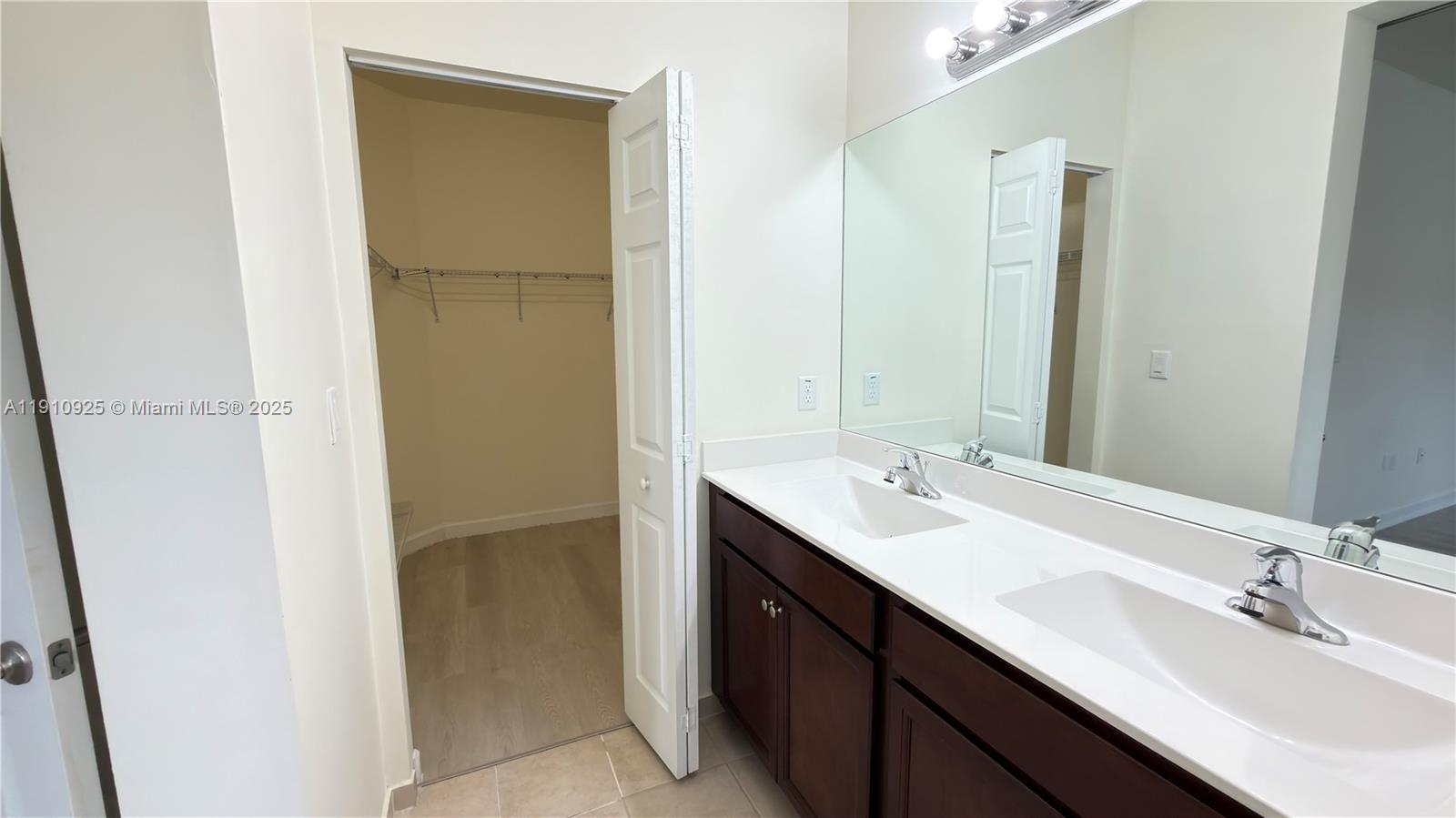 10337 West 34th Lane, Unit 10337 Hialeah, FL 33018 - Photo 32 of 50 a bathroom with a double vanity sink and a mirror