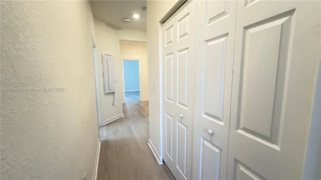 an empty room with wooden floor and closet