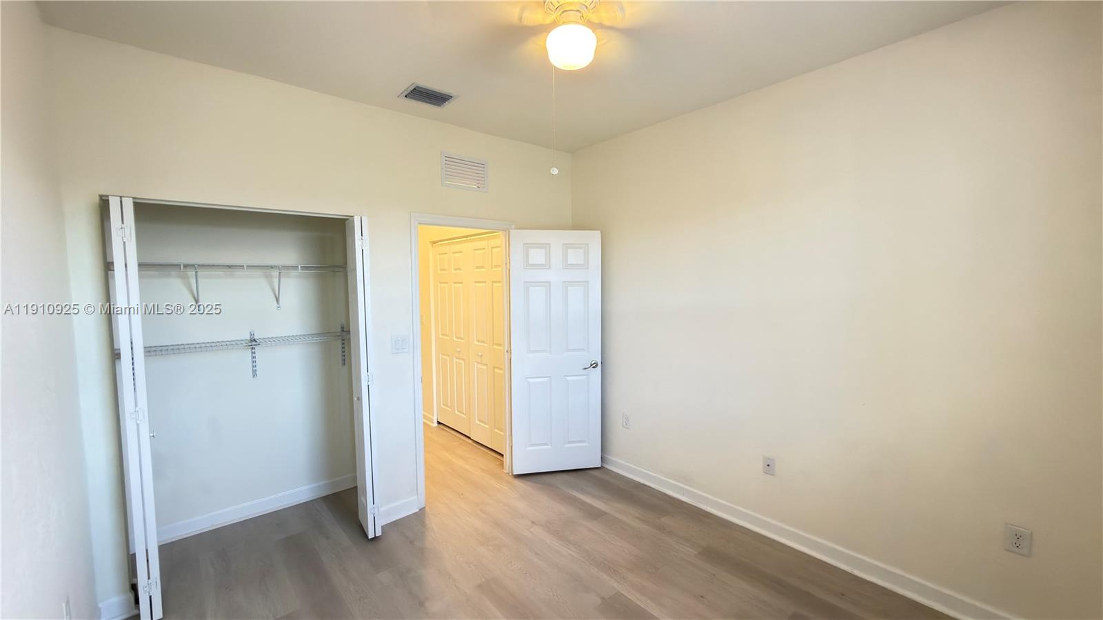 10337 West 34th Lane, Unit 10337 Hialeah, FL 33018 - Photo 39 of 50 an empty room with wooden floor and closet