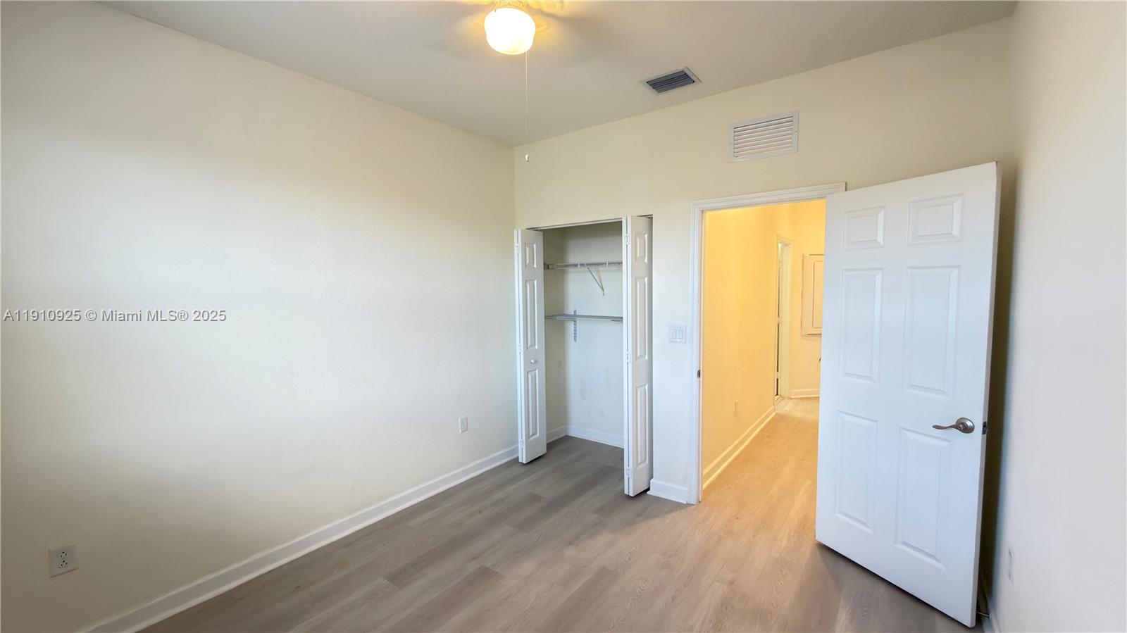 10337 West 34th Lane, Unit 10337 Hialeah, FL 33018 - Photo 40 of 50 a view of an empty room with closet and a window
