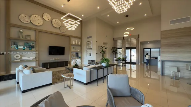 a very nice looking living room with a large window and dining table