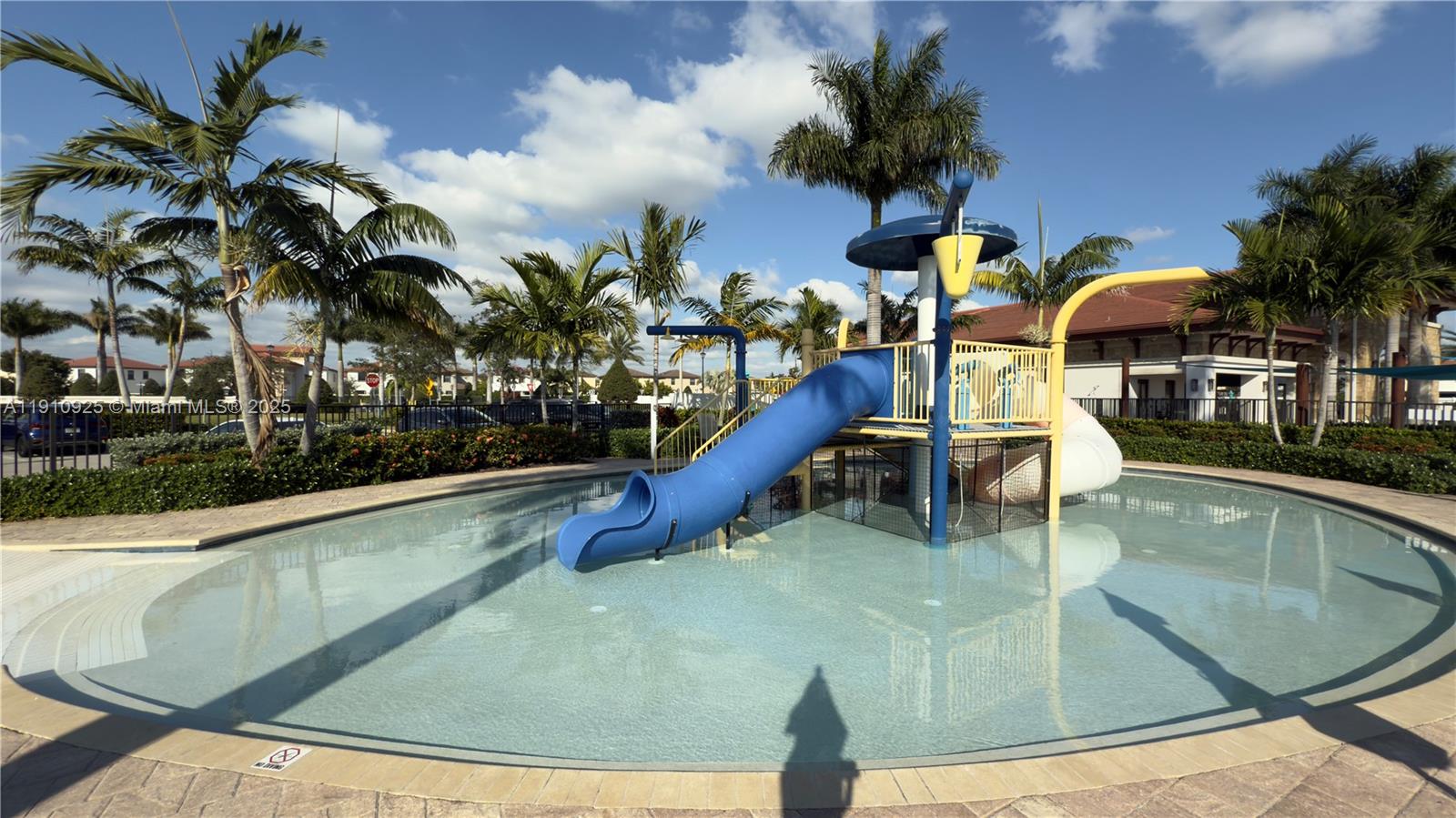 10337 West 34th Lane, Unit 10337 Hialeah, FL 33018 - Photo 49 of 50 a view of a swimming pool with a lounge chairs