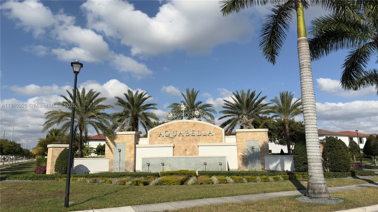 10337 West 34th Lane, Unit 10337 Hialeah, FL 33018 - Photo 50 of 50 a front view of multi story residential apartment building with yard and sign board