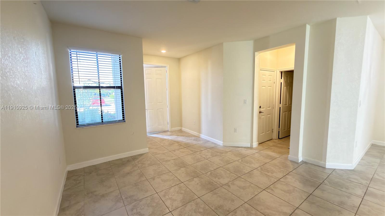 10337 West 34th Lane, Unit 10337 Hialeah, FL 33018 - Photo 5 of 50 a view of an empty room and window