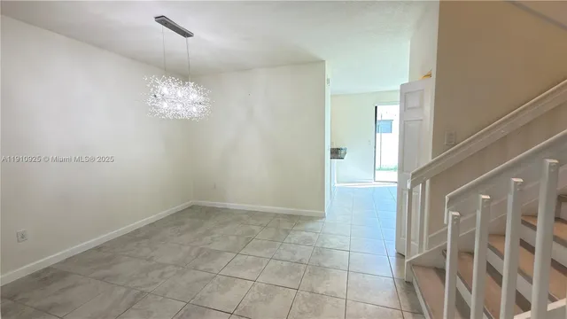 a view of livingroom with a chandelier fan and windows