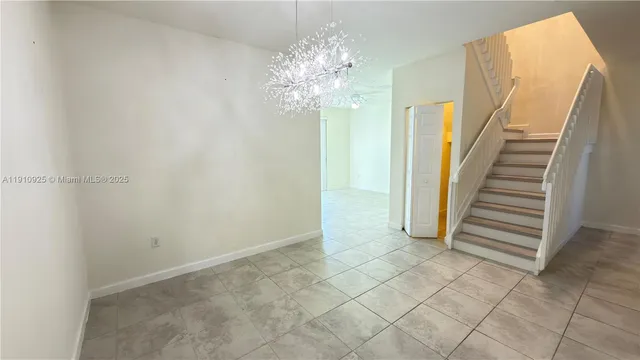 a view of a chandelier fan and entryway