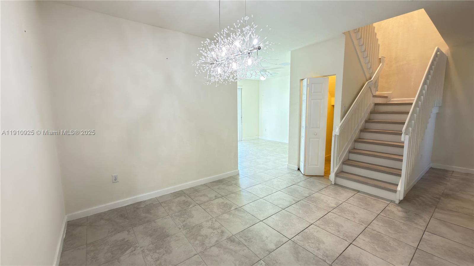 10337 West 34th Lane, Unit 10337 Hialeah, FL 33018 - Photo 10 of 50 a view of a chandelier fan and entryway