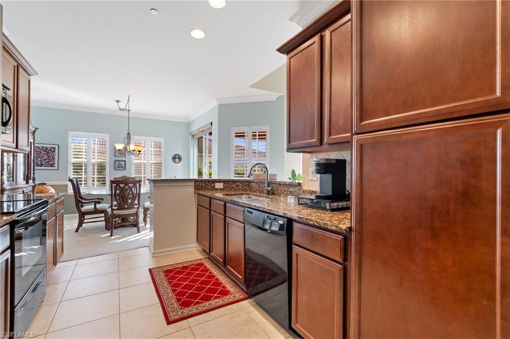 10057 Via Colomba Circle, Unit 206 Fort Myers, FL 33966 - Photo 22 of 46 a kitchen with stainless steel appliances granite countertop a sink stove and cabinets