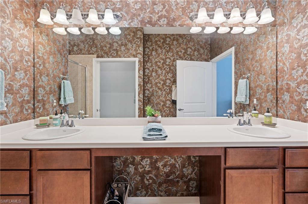 10057 Via Colomba Circle, Unit 206 Fort Myers, FL 33966 - Photo 29 of 46 a bathroom with a sink vanity and a mirror