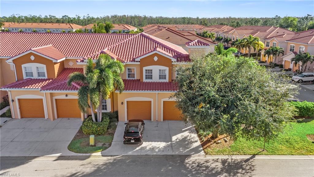 10057 Via Colomba Circle, Unit 206 Fort Myers, FL 33966 - Photo 3 of 46 an aerial view of a house with a garden and plants