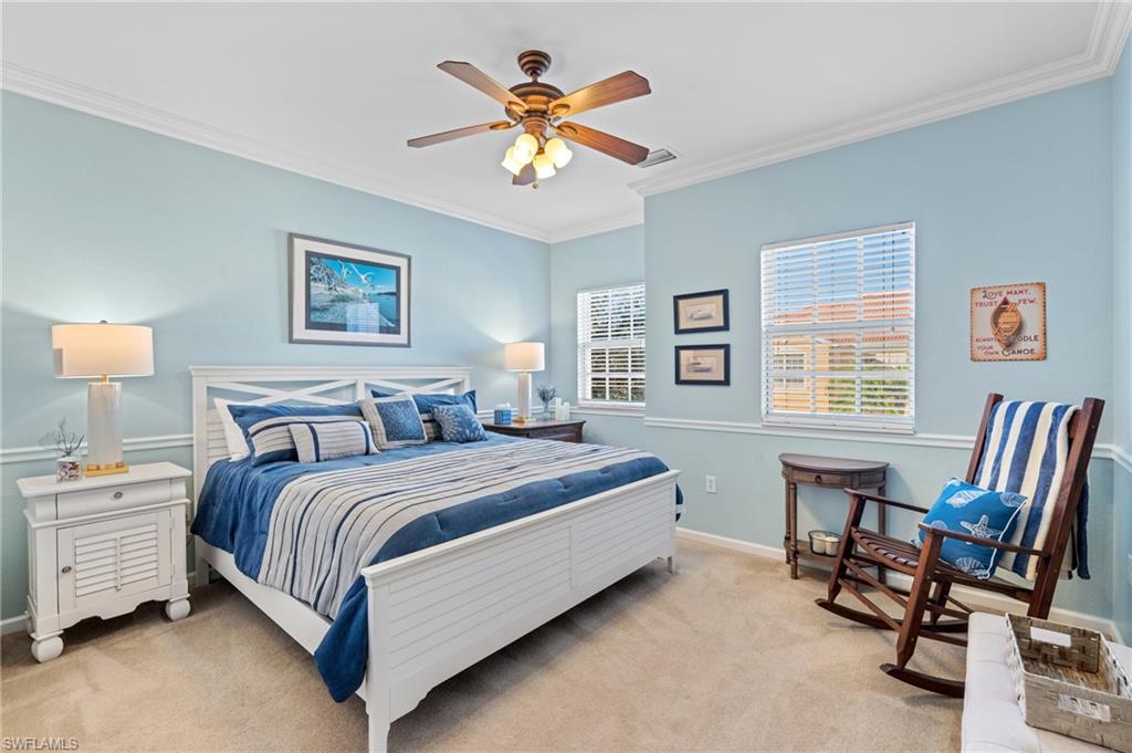 10057 Via Colomba Circle, Unit 206 Fort Myers, FL 33966 - Photo 36 of 46 a bedroom with a bed and a table in it