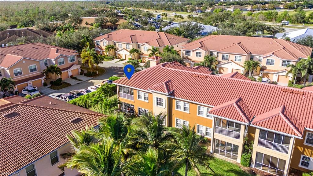 10057 Via Colomba Circle, Unit 206 Fort Myers, FL 33966 - Photo 43 of 46 an aerial view of residential houses with greenery space and a street view