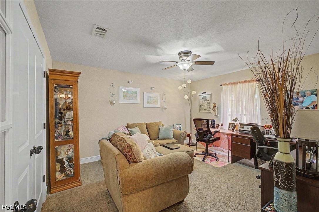 9915 Nichols Lake Road Milton, FL 32583 - Photo 24 of 41 a living room with furniture and a chandelier