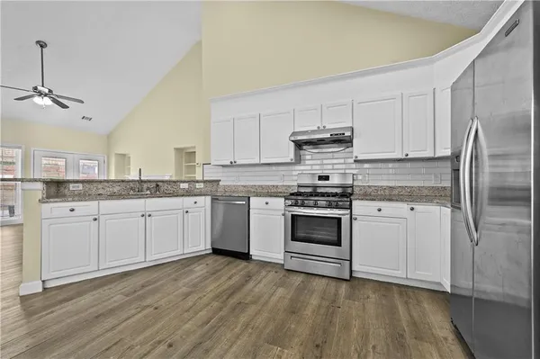 a kitchen with a white cabinets and white appliances