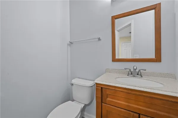 a bathroom with a toilet sink and mirror