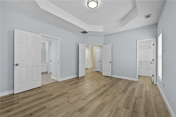 a view of an empty room with wooden floor