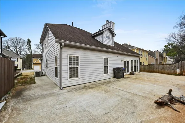 a view of a house with backyard and parking