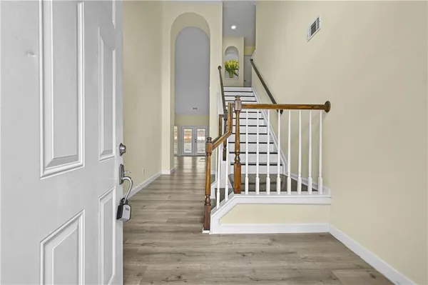 a view of staircase with railing and white walls