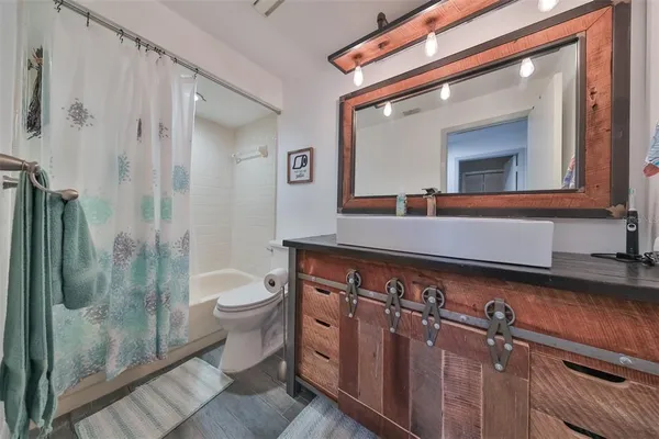 a bathroom with a toilet a sink and mirror