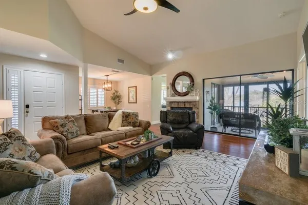 a living room with furniture wooden floor and a fireplace
