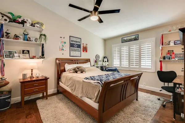 a bedroom with a bed dresser and a window