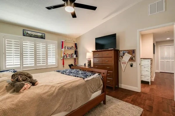 a bedroom with a bed and flat screen tv