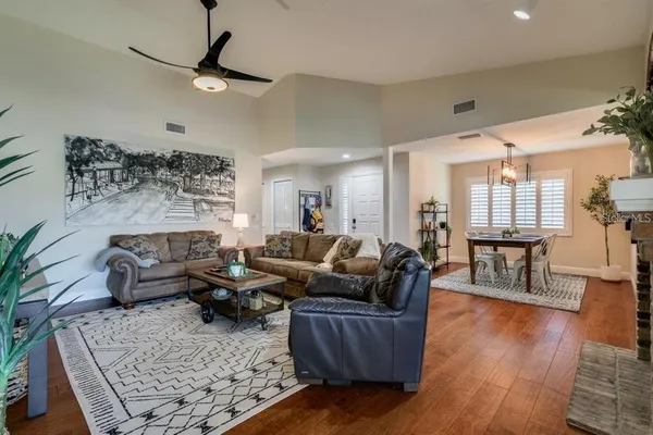 a living room with furniture wooden floor and a chandelier