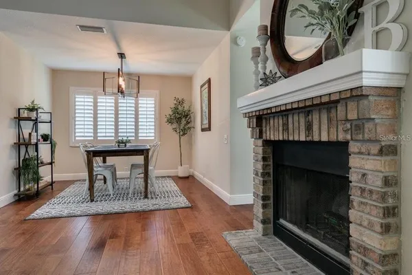 a dining room with a fireplace a desk and chair