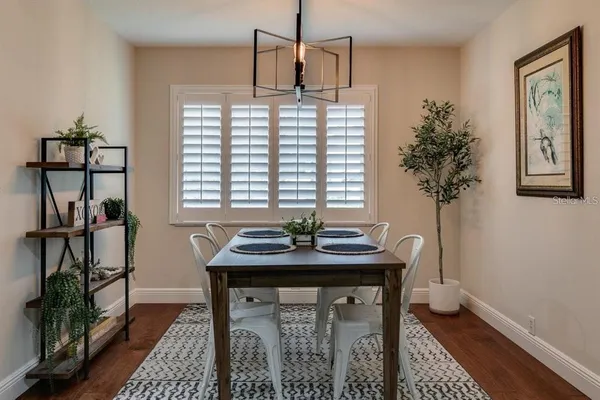 a view of a dining room with furniture window and wooden floor