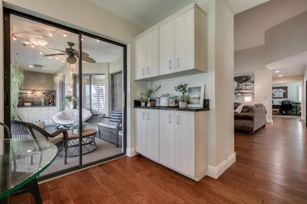 a living room with furniture a wooden floor and a glass door