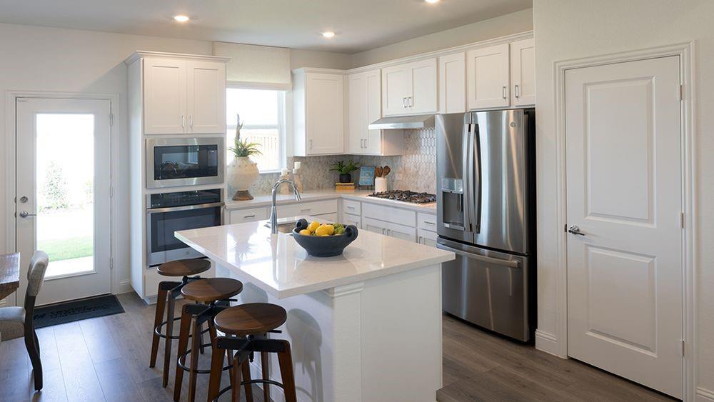 1425 Arciones Road Fort Worth, TX 76052 - Photo 4 of 17 a kitchen with stainless steel appliances a refrigerator and a stove top oven