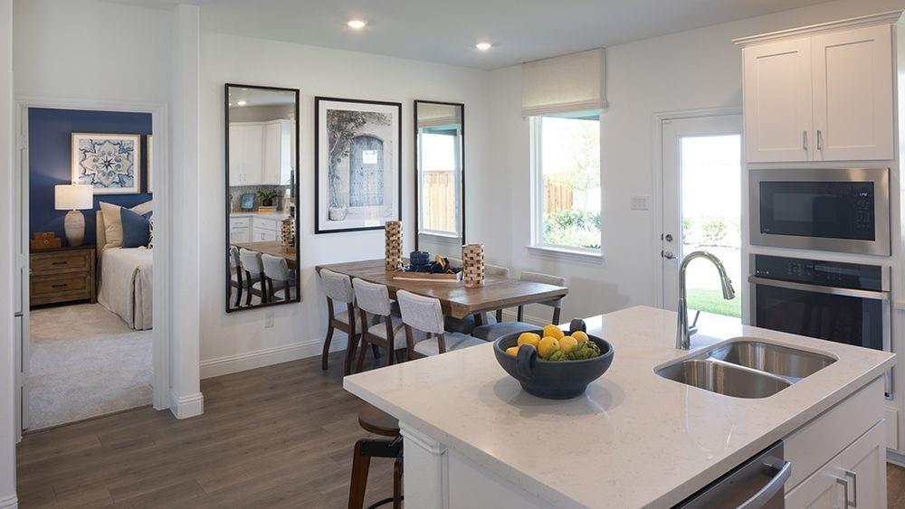 1425 Arciones Road Fort Worth, TX 76052 - Photo 5 of 17 a kitchen with a sink a stove and chairs