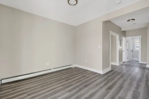 a view of a room with wooden floor